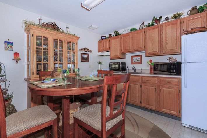 a kitchen with a red chair