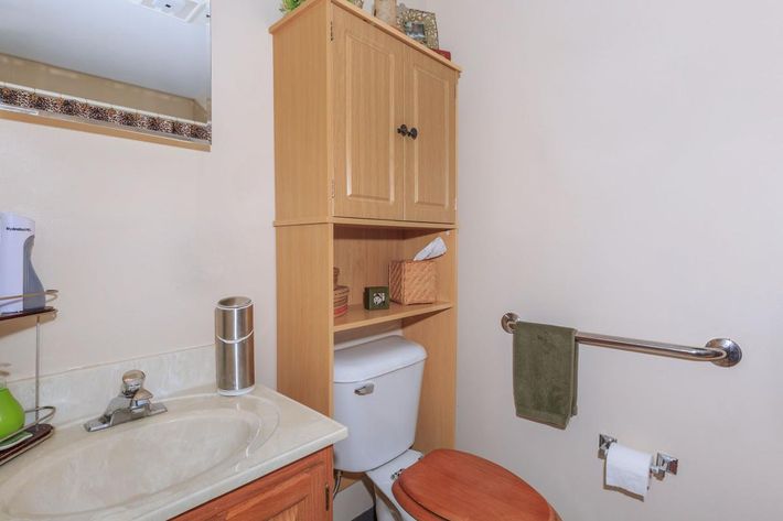 a white sink sitting under a mirror