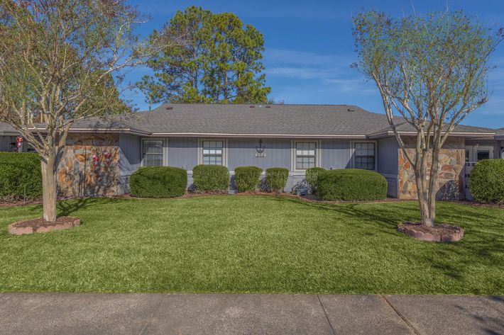 a house with a lawn in front of a building