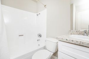 bathroom with white cabinets