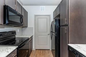 a stove top oven sitting inside of a kitchen