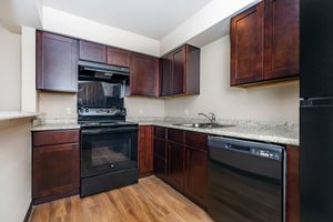 a kitchen with stainless steel appliances and wooden cabinets