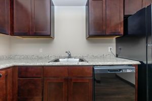 a kitchen with stainless steel appliances and wooden cabinets