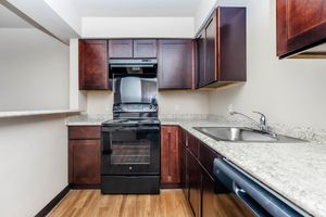 a kitchen with stainless steel appliances and wooden cabinets