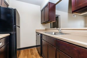 a kitchen with stainless steel appliances and wooden cabinets