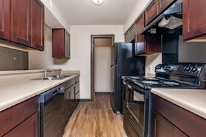 a modern kitchen with stainless steel appliances and wooden cabinets