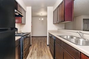 a modern kitchen with stainless steel appliances and wooden cabinets