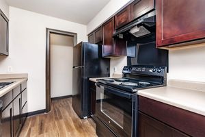 a modern kitchen with stainless steel appliances and wooden cabinets