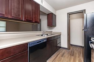 a kitchen with stainless steel appliances and wooden cabinets