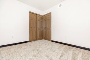 a bedroom with a wooden door