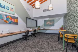 a bedroom with a desk and chair in a room