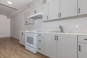 a kitchen with a sink and a refrigerator