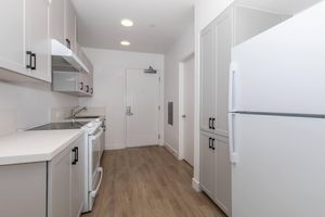 a kitchen with a sink and a refrigerator