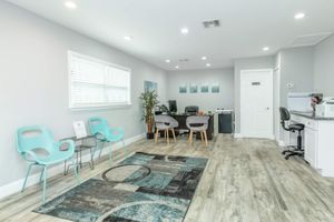 a living room filled with furniture and a large window