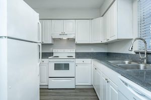 a kitchen with a stove and a refrigerator