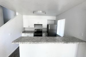 a kitchen with a sink and a microwave