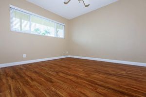 a bedroom with a wooden floor