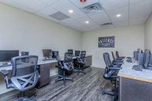 an office with a desk and chair in a room