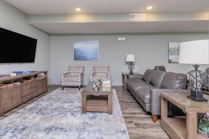 a living room filled with furniture and a flat screen tv