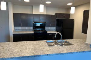 a kitchen with a table and a television