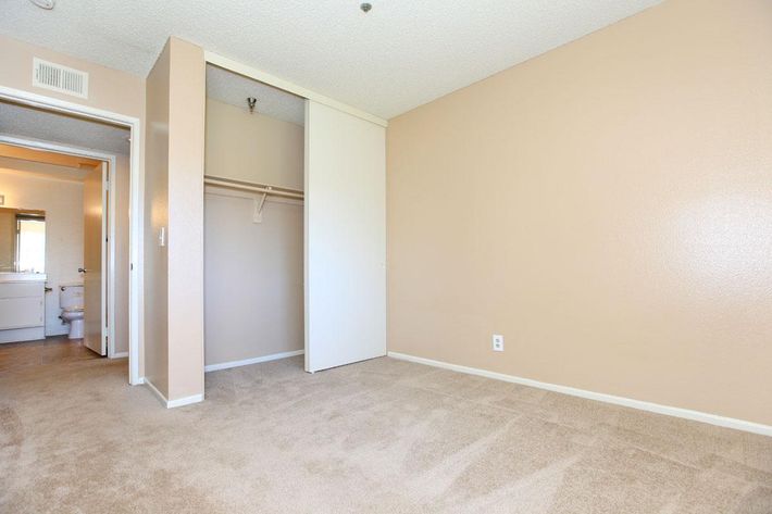 Bedroom with open sliding closet door