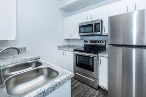 a kitchen with a stove top oven sitting inside of a microwave