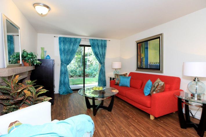 a living room filled with furniture and a flat screen tv