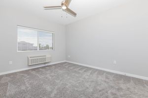 a bedroom with a large window