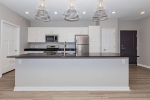 a kitchen with an island in the middle of a room