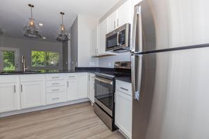 a kitchen with a stove and a refrigerator