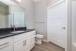 a kitchen with a sink and a mirror