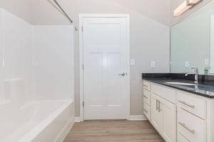 a kitchen with a sink and a mirror