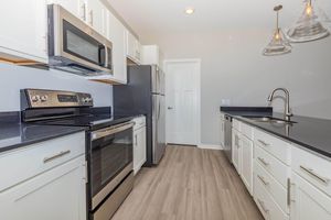 a stove top oven sitting inside of a kitchen