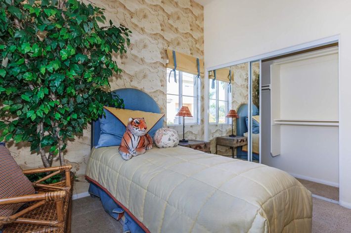a bedroom with a bed in a room