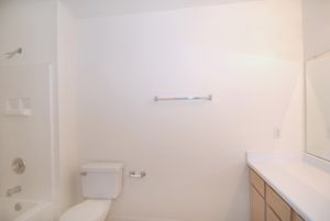 a white sink sitting next to a shower