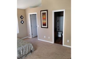 a bedroom with a bed in a room
