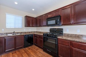 a kitchen with stainless steel appliances and wooden cabinets