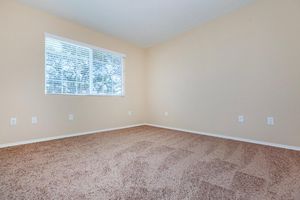 a bedroom with a large window