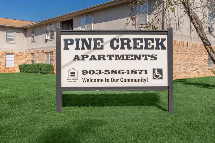 a sign in front of a house