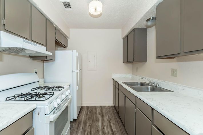 a kitchen with a sink and a mirror