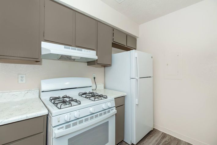 a kitchen with a stove top oven sitting inside of a refrigerator