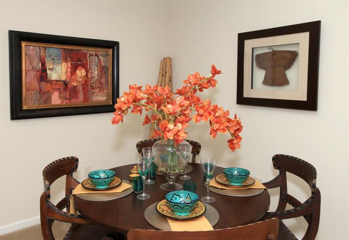 a living room filled with furniture and vase on a table