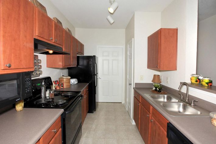 a kitchen with stainless steel appliances and wooden cabinets