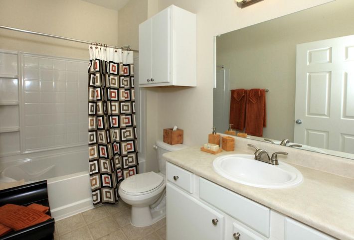 a kitchen with a sink and a mirror