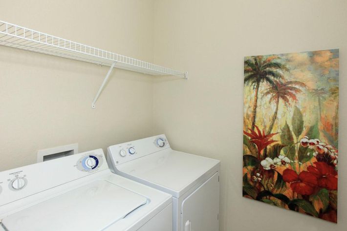 a white sink sitting under a microwave