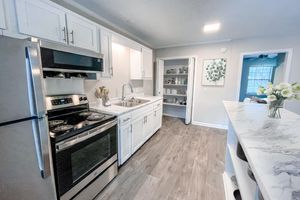 a kitchen with a stove top oven sitting inside of a building