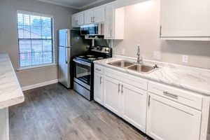 a kitchen with a sink and microwave