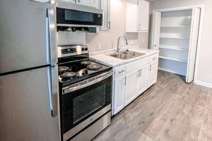 a kitchen with a stove and refrigerator