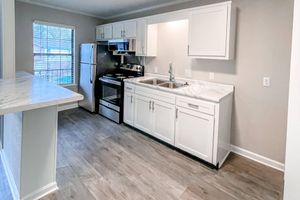 a kitchen with white cabinets