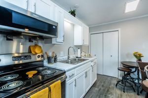 a stove top oven sitting inside of a kitchen